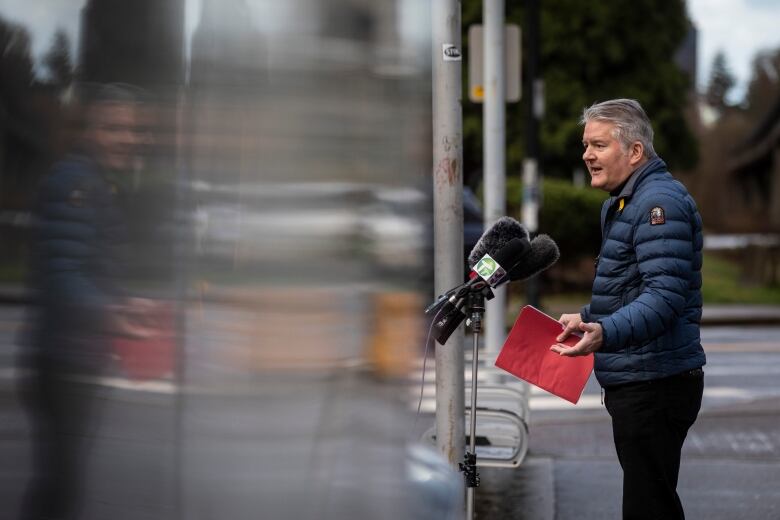 Man stands a outdoor podium