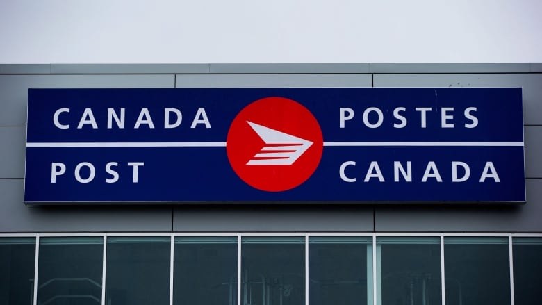 A red and blue sign on an office building reads 