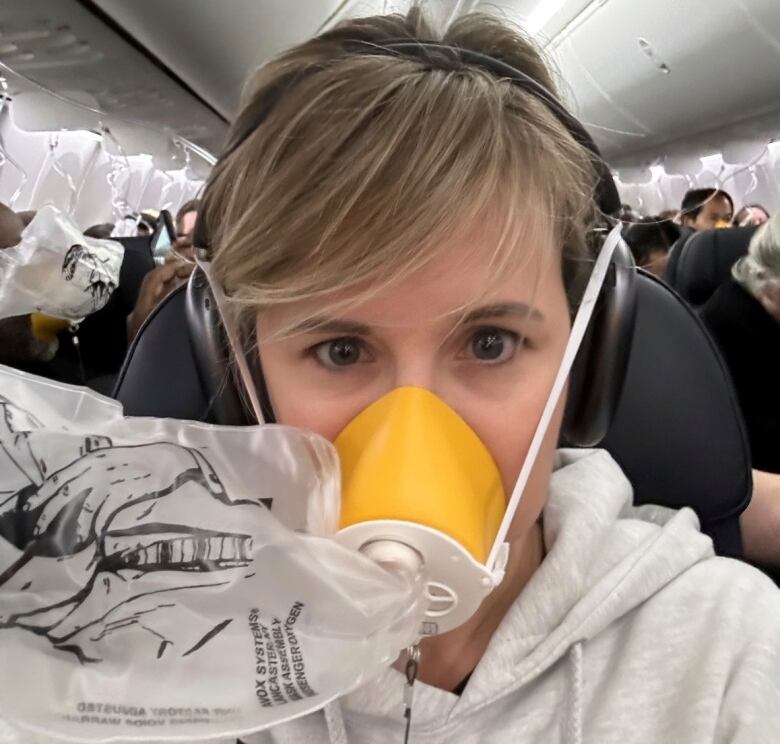 An air traveller wears an oxygen mask.