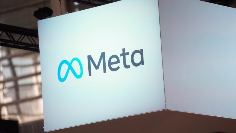 The Meta logo on a lit-up screen.