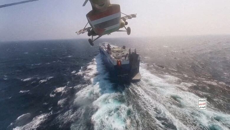 A helicopter is shown over a ship.