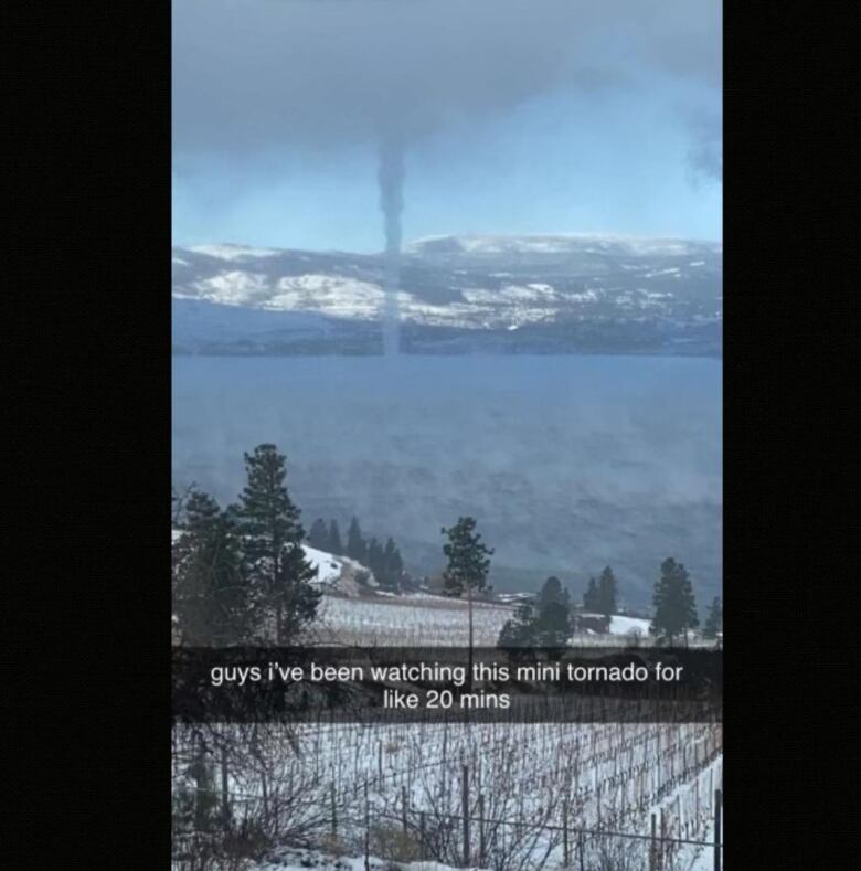 A Snapchat image of what looks like a small tornado over a lake.