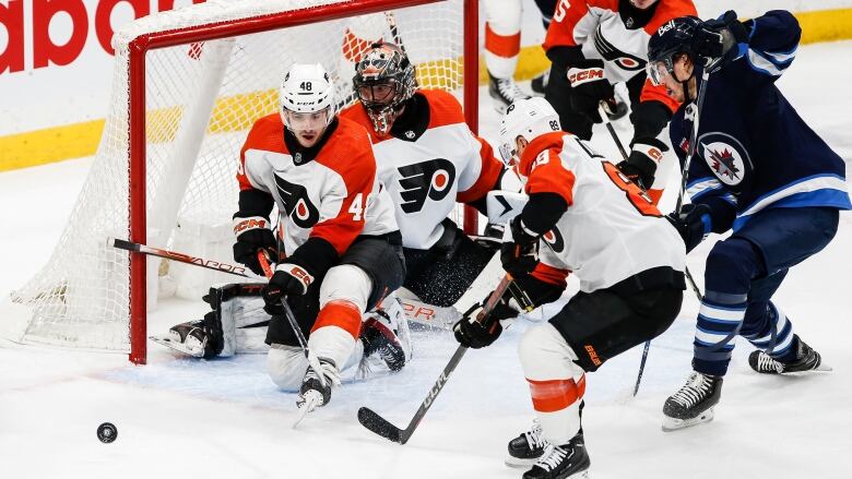 A non-goalie makes a save during a hockey game.