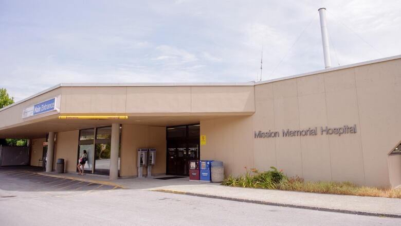 A short squat building with the words 'Mission Memorial Hospital' on its side.