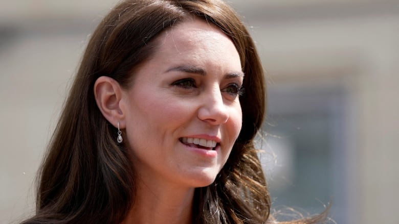 A woman with brown hair in a yellow outfit.