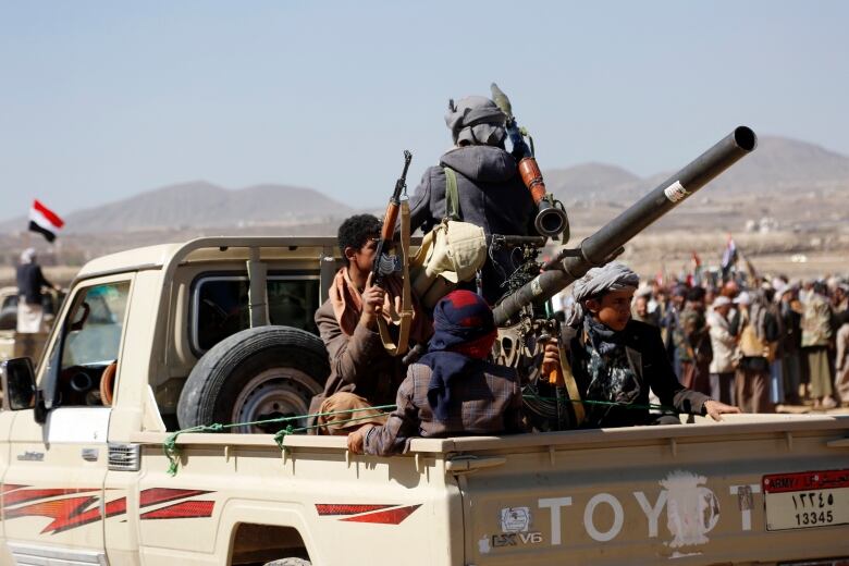 Houthi fighters and tribesmen stage a rally against the U.S. and the U.K. strikes on Houthi-run military site