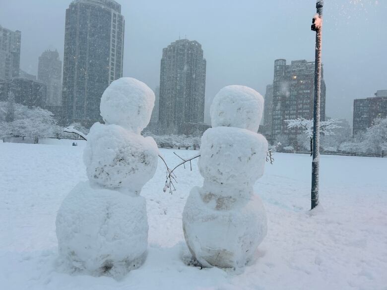 Two snow people made at a park in Downtown Vancouver during a snowstorm on Wednesday Jan. 17, 2024.