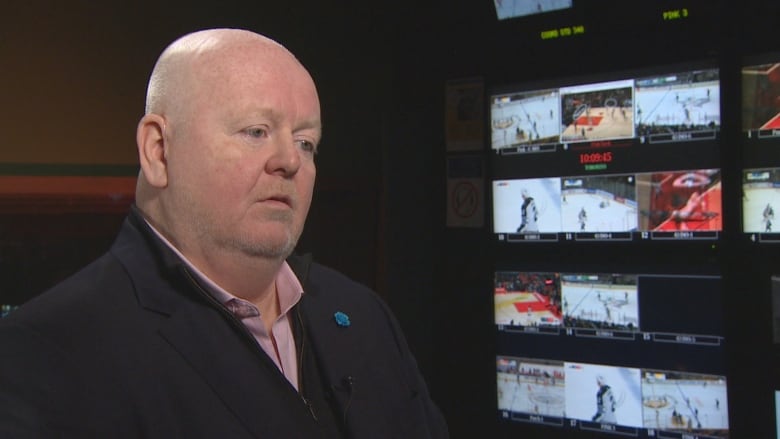 A close shot of a man in a TV control room.