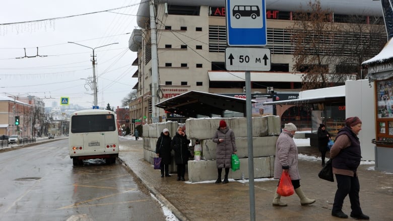 People are seen waiting at a bus stop in Belgorod, Russia, in mid-January 2024.