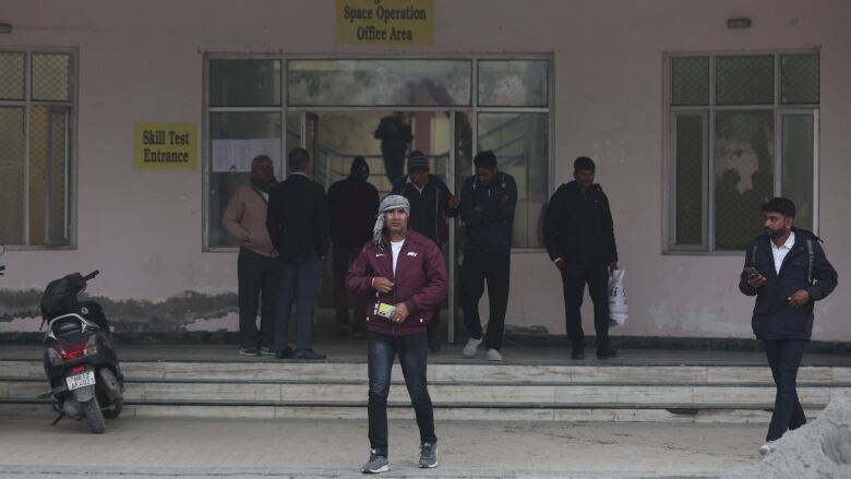 Skilled workers in Indian are seen leaving a university building in Rohtak, India, after taking a skill-related test.