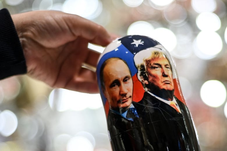 Close-up of a Russian nesting doll wrapped in an image representing Russian President Vladimir Putin and former U.S. president Donald Trump.