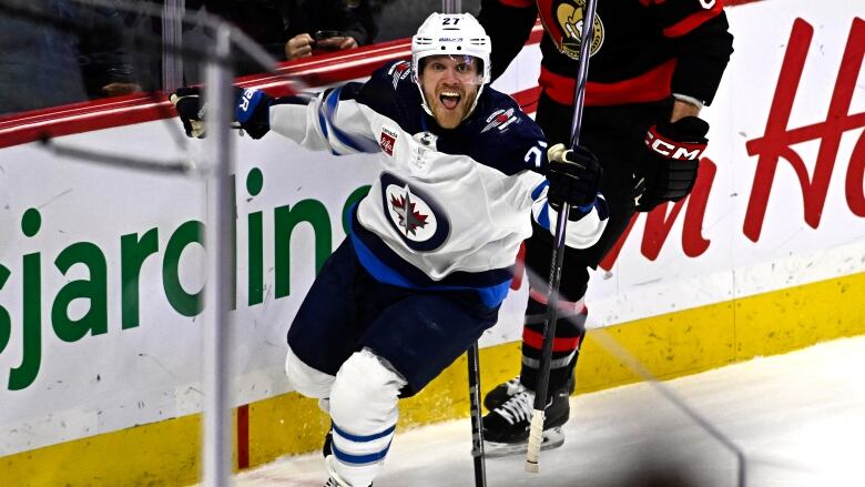 Hockey player celebrates scoring a goal.