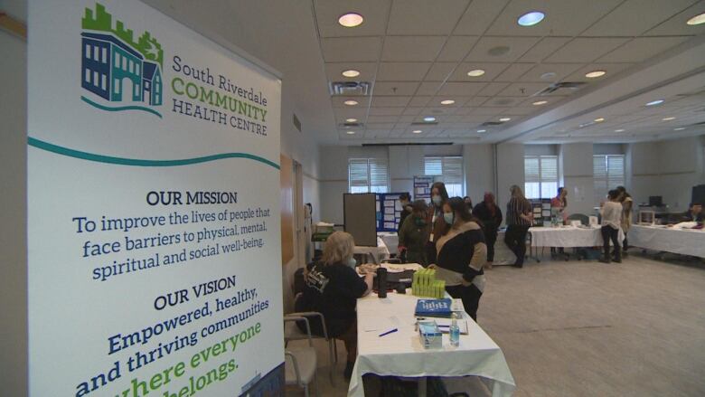 People visit booths in a room at the South Riverdale Community Health Centre.