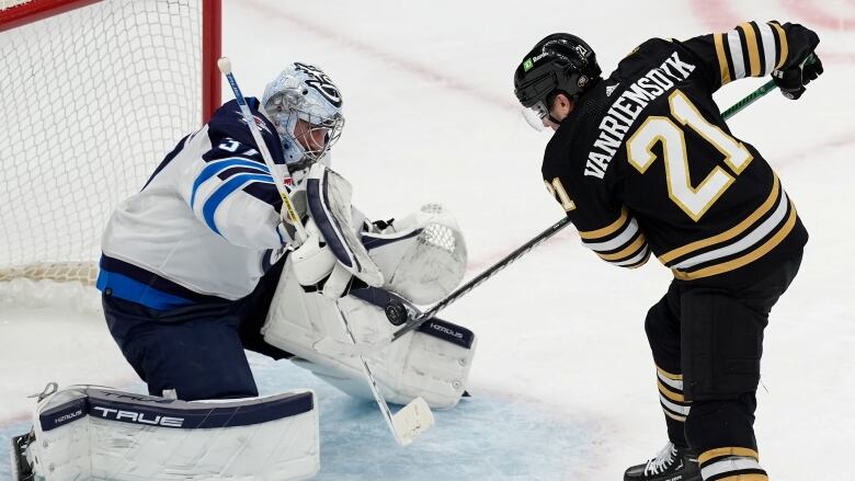 A goalie makes a save in front of his net.