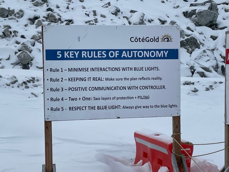 A white sign with a list of five safety rules.