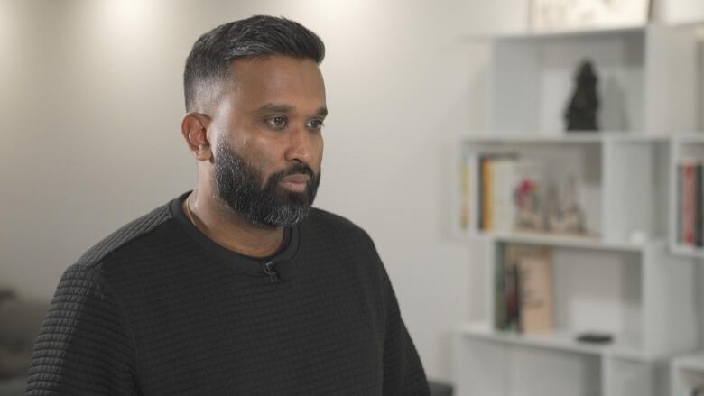 Realtor and real estate law expert, Varun Sriskanda sitting in his livingroom. 