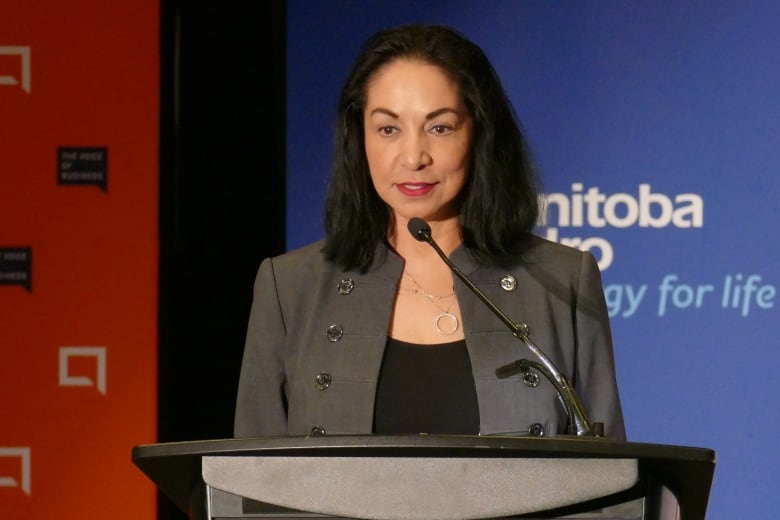 A woman speaks at a podium.