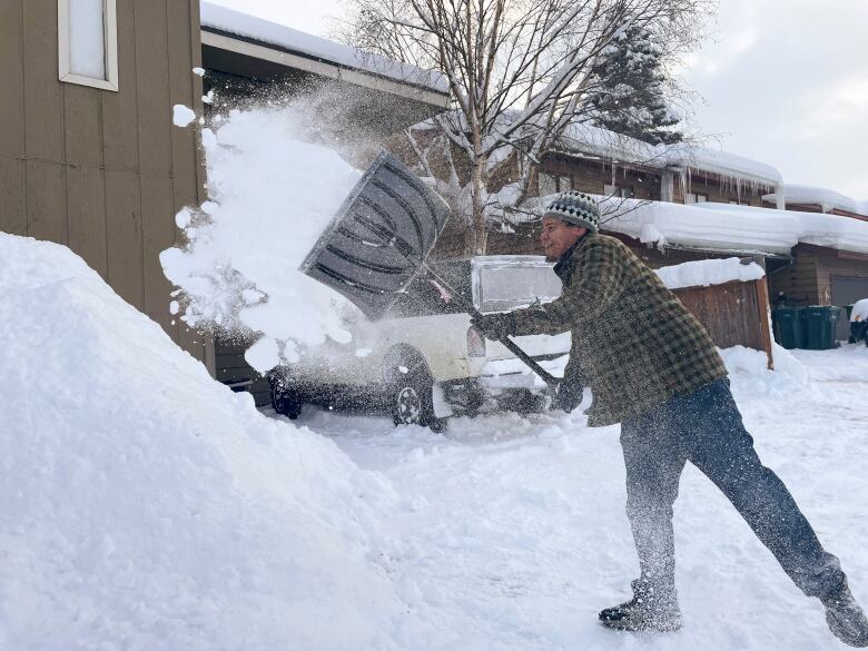 A man shovelling snow.