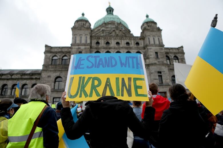 Hundreds of people gathered in solidarity for the people of Ukraine during a rally organized by the Ukrainian Canadian Congress on the steps of the B.C. Legislature in Victoria, Sunday, Feb. 27, 2022.