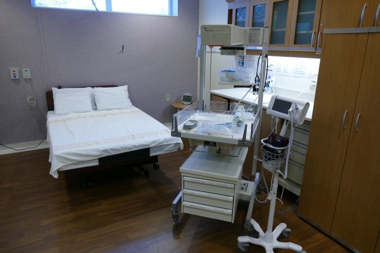 A room with a bed and equipment