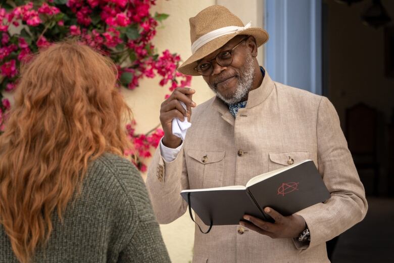 A man tips his hat to a woman facing away from us, toward him. 