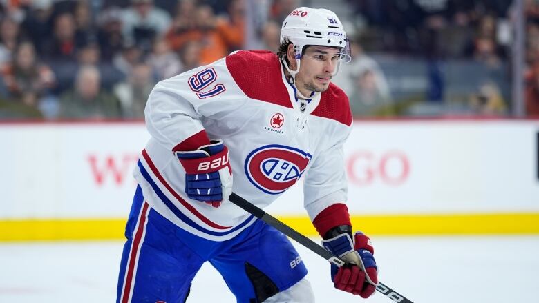 A hockey player eyes the puck.