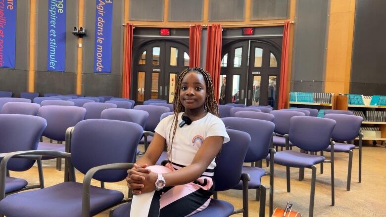 A child sits on a chair.