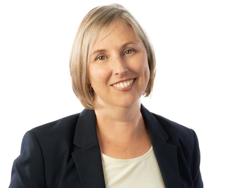 A portrait of a woman wearing a black blazer