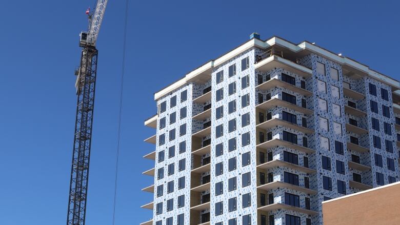 apartment under construction with crane