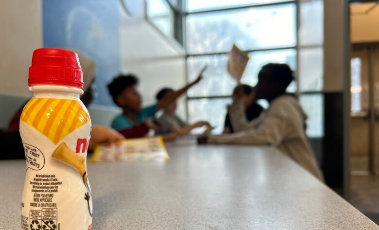 Youths sitting at a table.