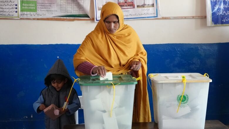 A woman votes in Pakistan's Punjab province during the country's general election on February 8, 2024. 