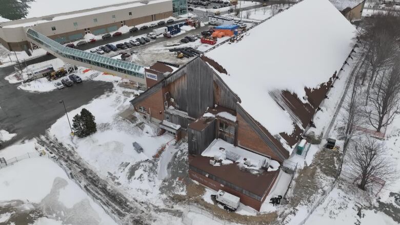 Image of building in the shape of a long trainable covered in snow.