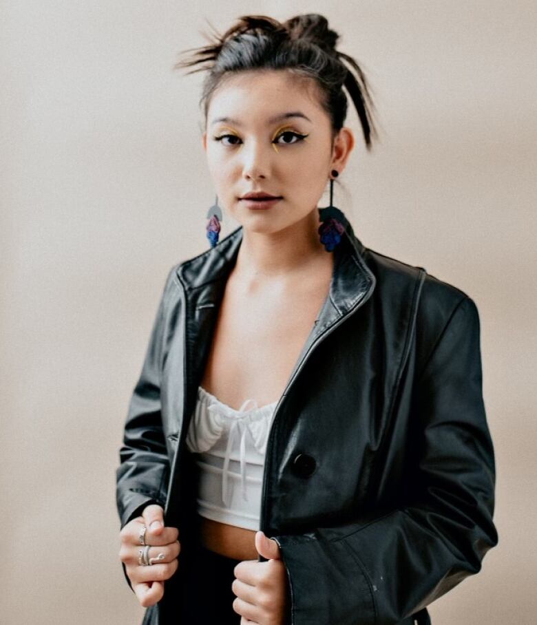 Kiawentiio poses wearing a leather jacket.