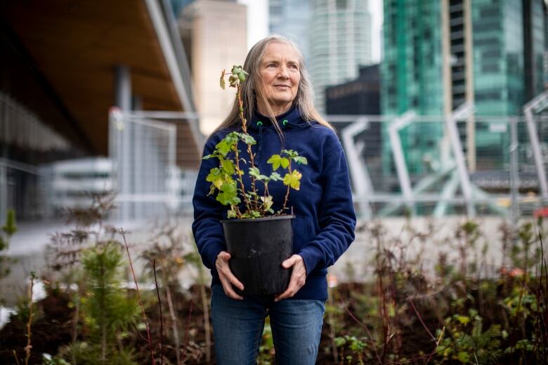 woman holding tree