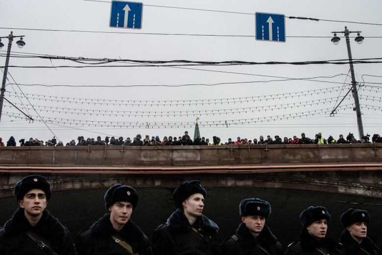 A March 1, 2015 file photo shows people gathered on a Moscow bridge to march in memory of slain Russian opposition leader Boris Nemtsov.