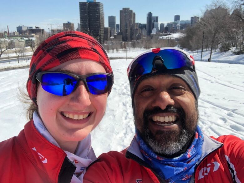 two people smiling while skiing