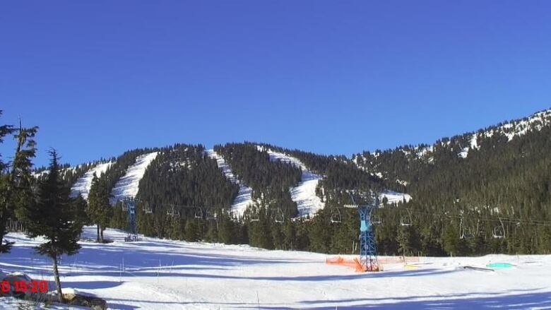 mountain with snow covered ski runs and a chair lift