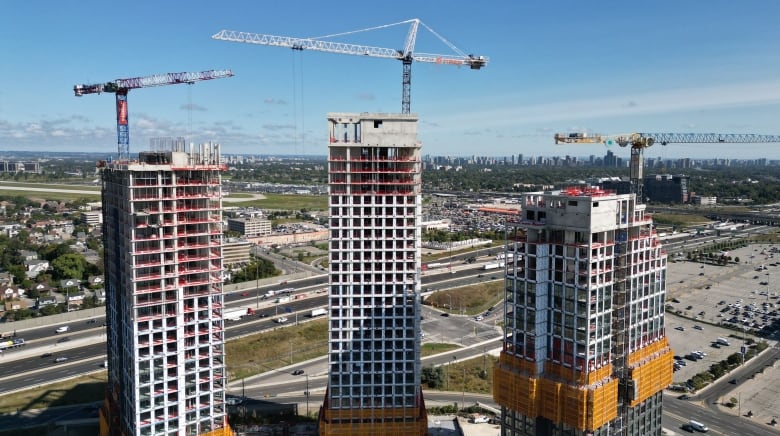 Aerial view of three high-rise residential towers under construction on Dufferin Street in North York. 