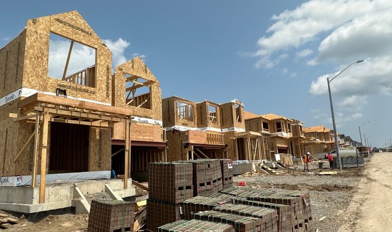 A street of partially built homes under construction. 