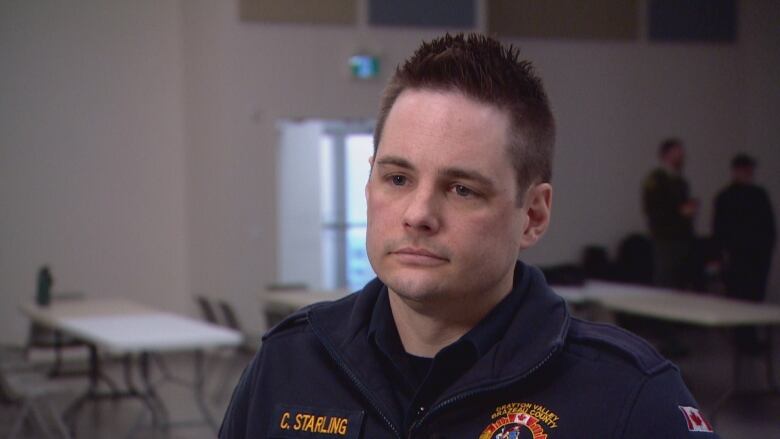 A man with brown hair wears a uniform for the Drayton Valley/Brazeau County Fire Services.