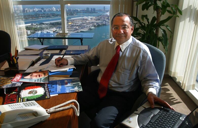 Former U.S. diplomat Victor Manuel Rocha is seen posing for a photo in a Miami office back in January 2003.