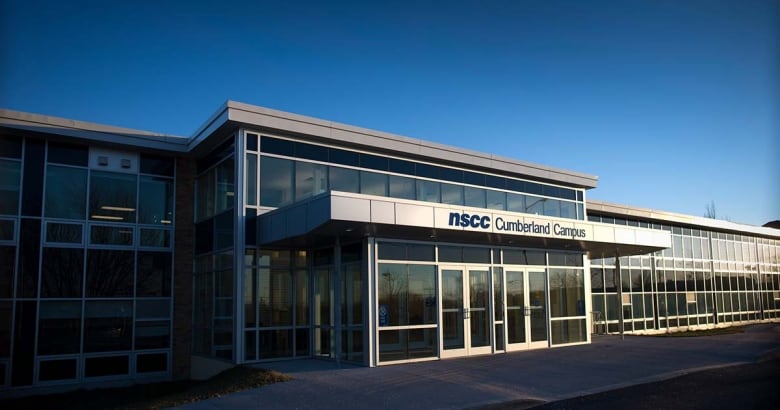 A glass and metal entrance to a community college.