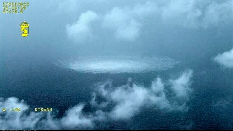 A large body of water is shown, with clouds shown above a large surface bubbling.