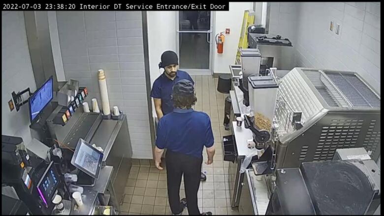 Two men in a McDonald's kitchen. 