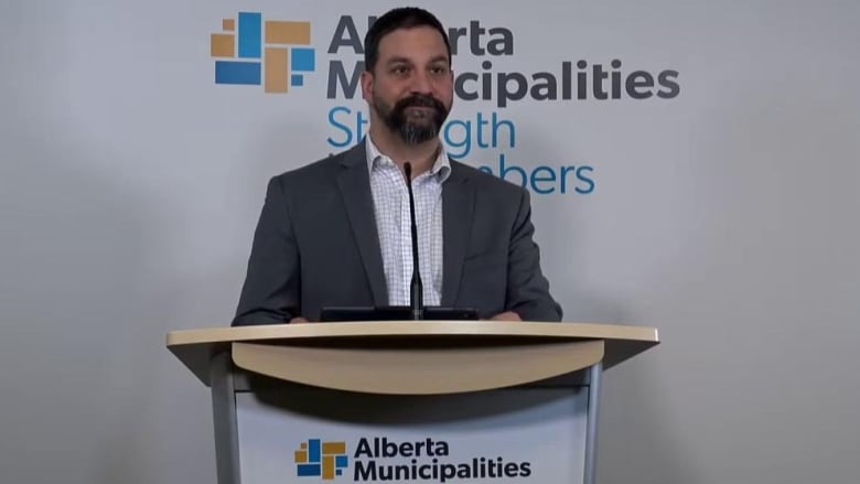 A man stands behind a podium.