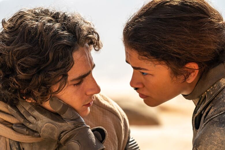 Zendaya holds Timothe Chalamet's face in a still take from the movie Dune: Part Two 