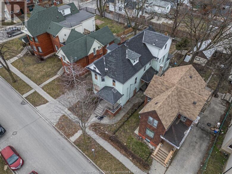 An overhead view of a large house in need of repair.