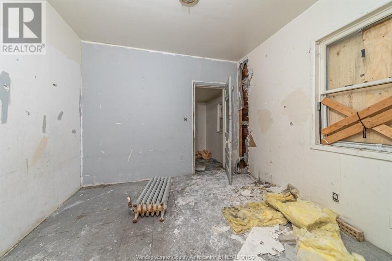 A room in a house in dire need of repair and renovation.