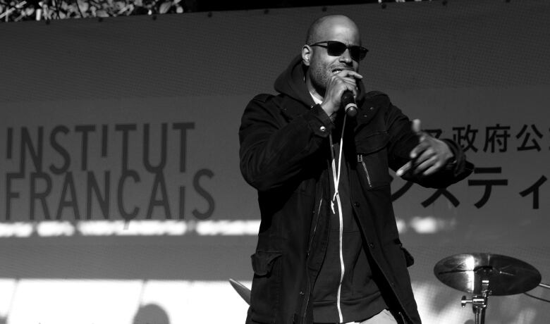 A man rapping in a black and white photo.