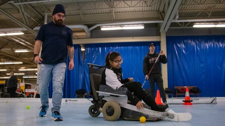 A teenager drives a motorized wheelchair for sports.